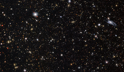 A wide field image of showing thousands of galaxies and stars.